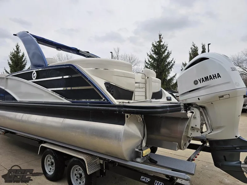 Slide: The Image of 2021 Bennington RX 25 Quad Bench pontoon boat with Yamaha outboard engine on trailer. - 24