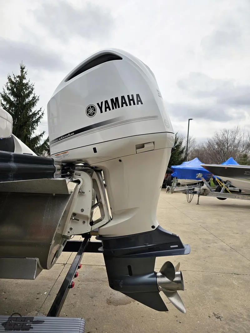 Slide: The Image of 2021 Bennington RX 25 Quad Bench with Yamaha outboard motor, outdoor setting. - 26