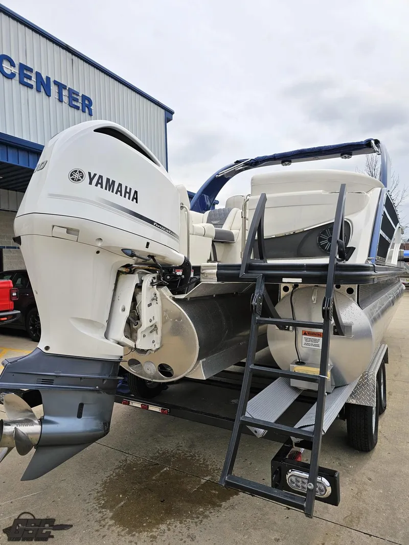 Slide: The Image of 2021 Bennington RX 25 Quad Bench with Yamaha outboard motor, docked at a marina. - 28