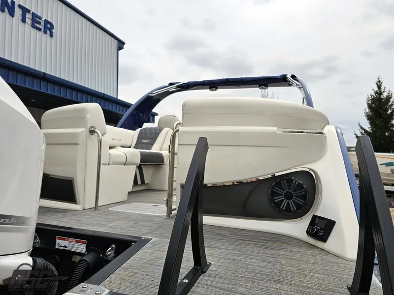 Slide: The Image of 2021 Bennington RX 25 Quad Bench pontoon boat with spacious seating and modern design. - 31
