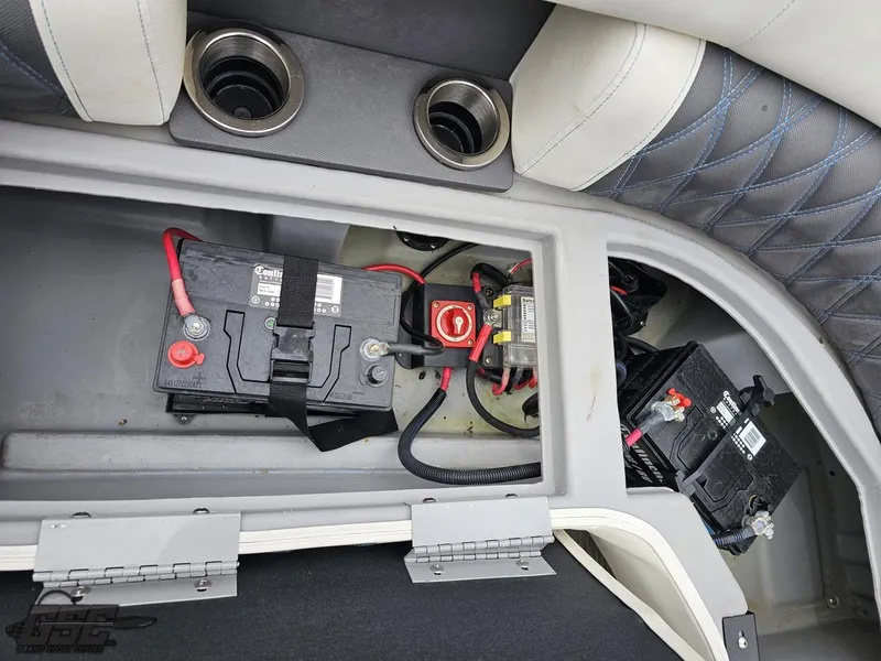 Slide: The Image of 2021 Bennington RX 25 Quad Bench battery compartment with dual batteries and wiring. - 46