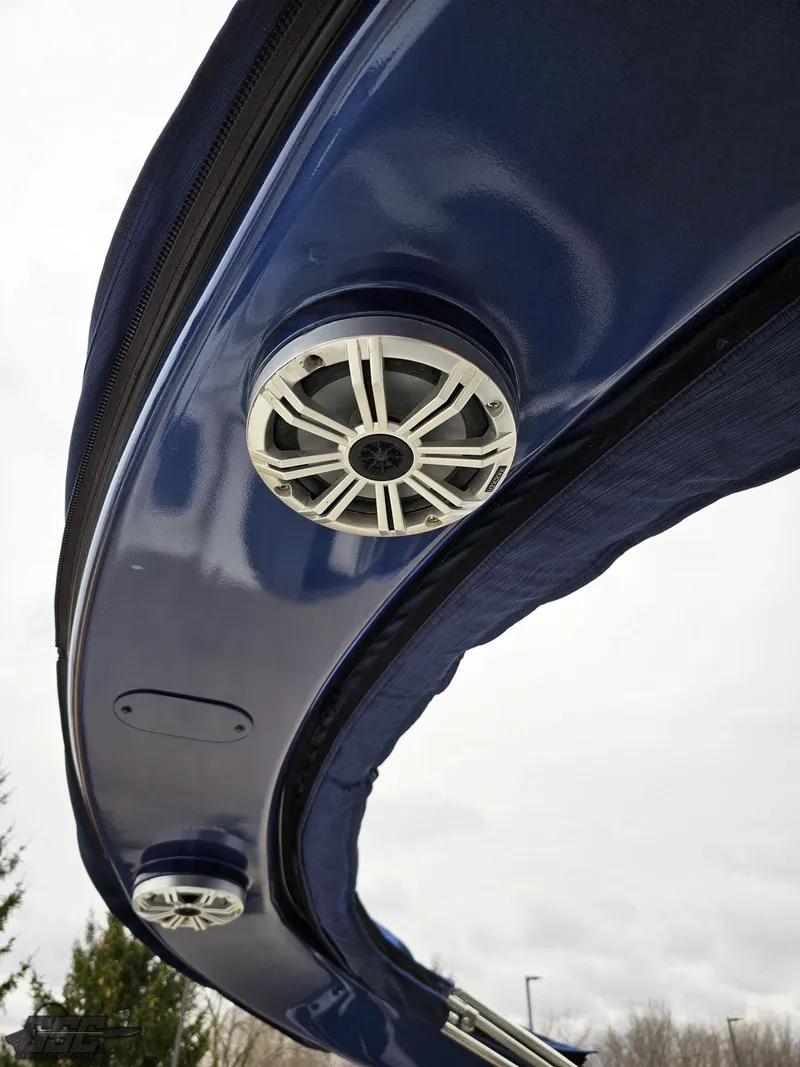 Slide: The Image of 2021 Bennington RX 25 Quad Bench boat speakers on a sleek blue canopy. - 49