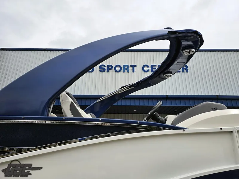 Slide: The Image of 2021 Bennington RX 25 Quad Bench boat at a sport center, featuring sleek design. - 9