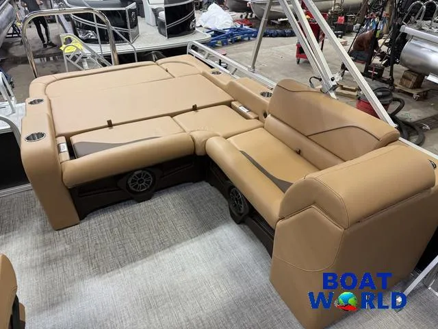 Slide: The Image of 2025 Tahoe Sport 2385 Swingback Tritoon with tan seating, showcased at Boat World. - 17
