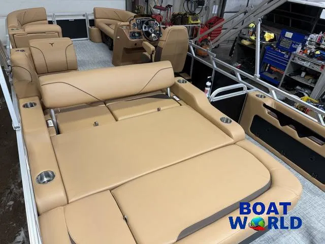 Slide: The Image of 2025 Tahoe Sport 2385 Swingback Tritoon with tan seating, showcased at Boat World. - 19