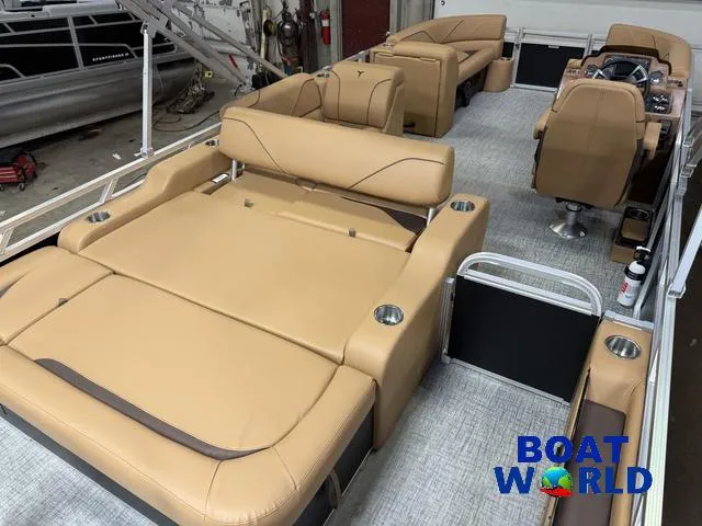 Slide: The Image of 2025 Tahoe Sport 2385 Swingback Tritoon interior with tan seating and modern design. - 20