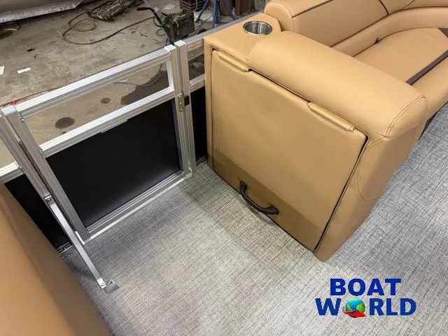 Slide: The Image of 2025 Tahoe Sport 2385 Swingback Tritoon interior with tan seating and metal railing. - 24