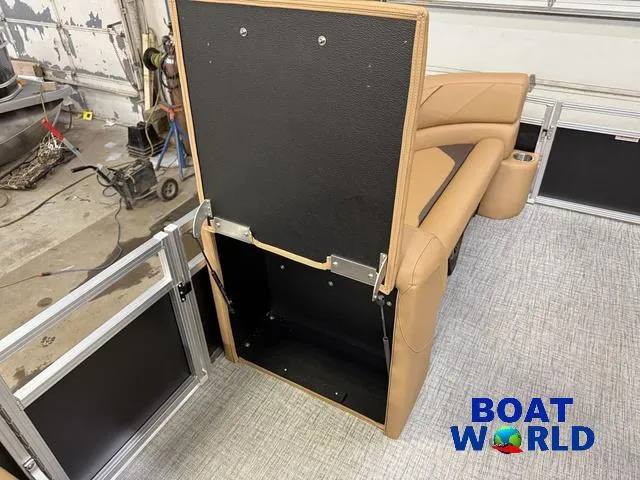 Slide: The Image of 2025 Tahoe Sport 2385 Swingback Tritoon interior with storage compartment open. - 25