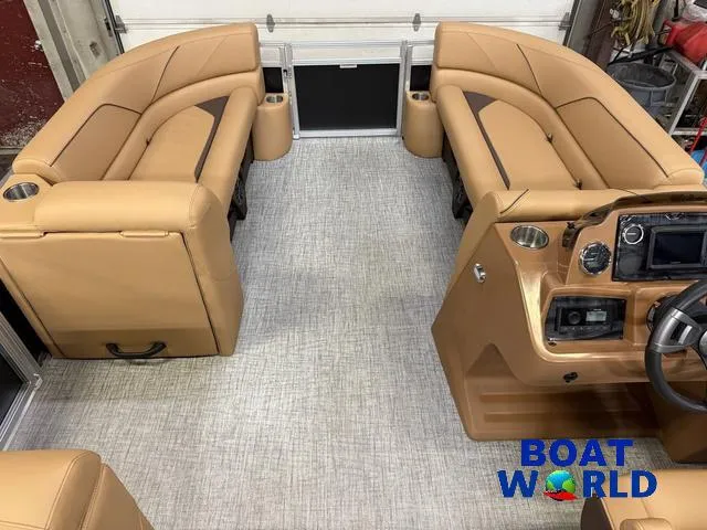Slide: The Image of Interior of 2025 Tahoe Sport 2385 Tritoon with tan seating and modern dashboard. - 26