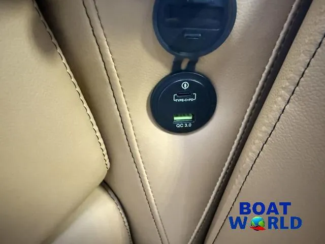 Slide: The Image of 2025 Tahoe Sport 2385 Tritoon USB charging port, featuring QC 3.0 technology. - 28