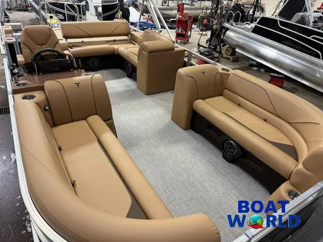 Slide: The Image of 2025 Tahoe Sport 2385 Swingback Tritoon with tan seating, showcased at Boat World. - 30