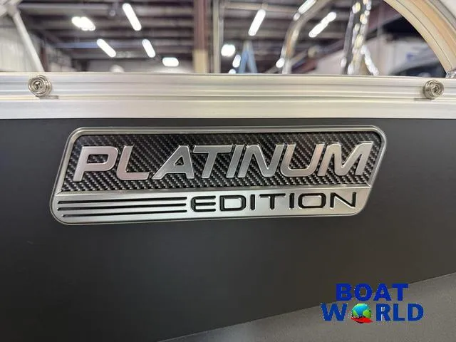 Slide: The Image of 2025 Tahoe Sport 2385 Tritoon Platinum Edition badge at Boat World showroom. - 36