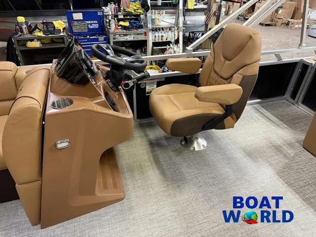 Slide: The Image of 2025 Tahoe Sport 2385 Swingback Tritoon interior with captain's chair and control panel. - 9