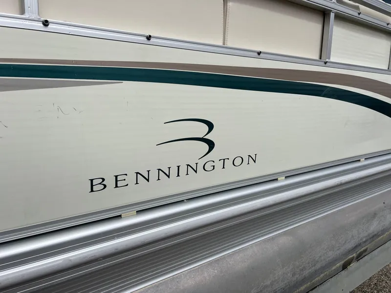 Slide: The Image of 2002 Bennington 2575 FS boat side view with logo and design details. - 10