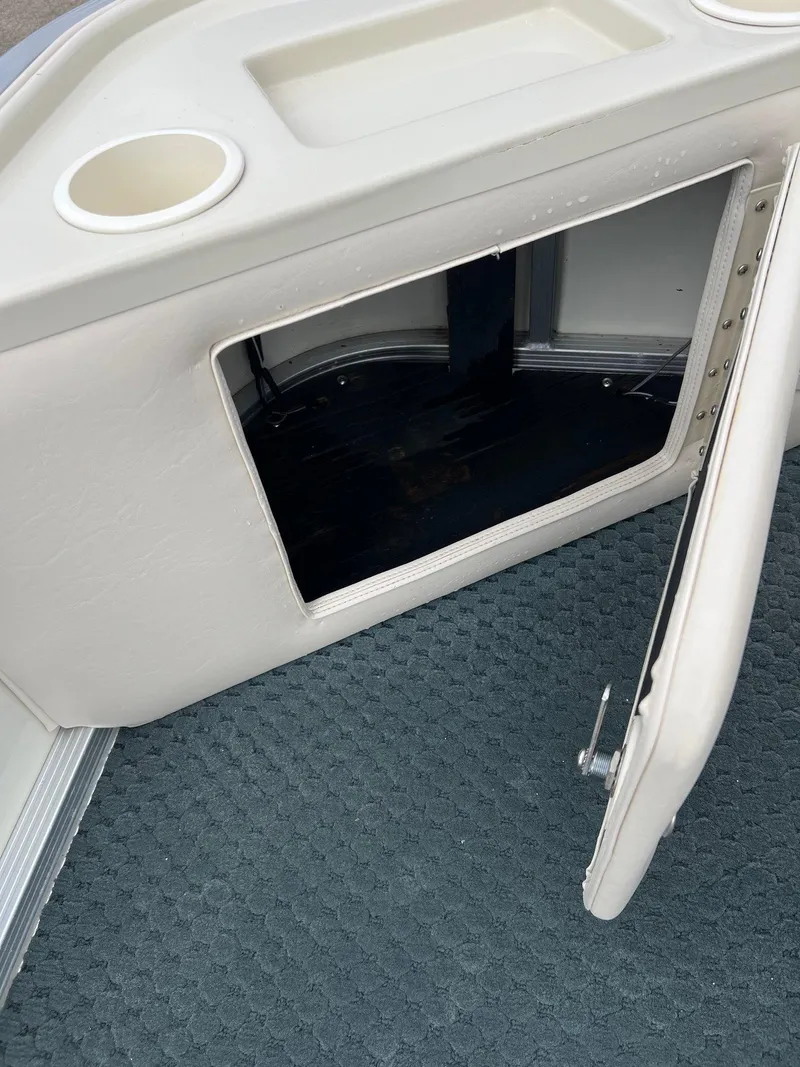 Slide: The Image of Open storage compartment on 2002 Bennington 2575 FS boat with textured flooring. - 15