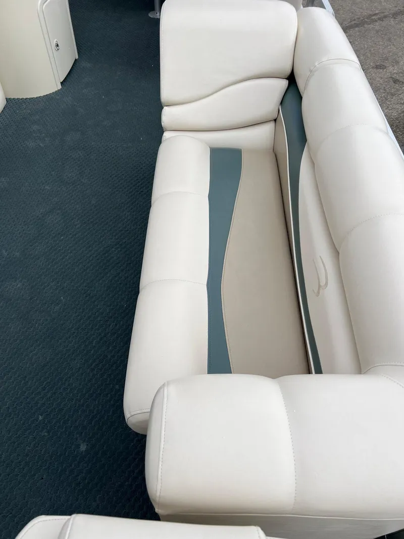 Slide: The Image of 2002 Bennington 2575 FS boat interior with white cushioned seating. - 20