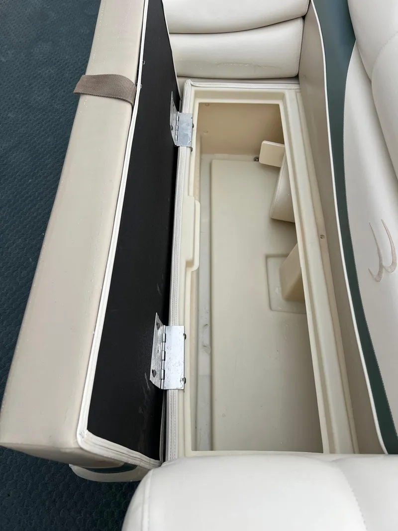 Slide: The Image of Open storage compartment in a 2002 Bennington 2575 FS boat seat. - 21
