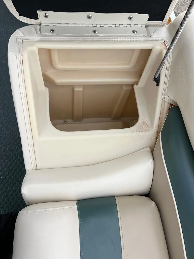 Slide: The Image of Open storage compartment in a 2002 Bennington 2575 FS boat with cushioned seating. - 22