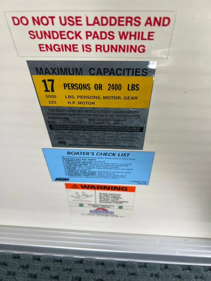 Slide: The Image of 2002 Bennington 2575 FS capacity and safety labels, including weight limits and operational warnings. - 29