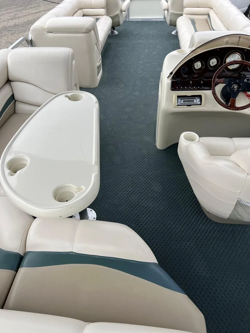 Slide: The Image of 2002 Bennington 2575 FS pontoon boat interior with plush seating and steering console. - 33