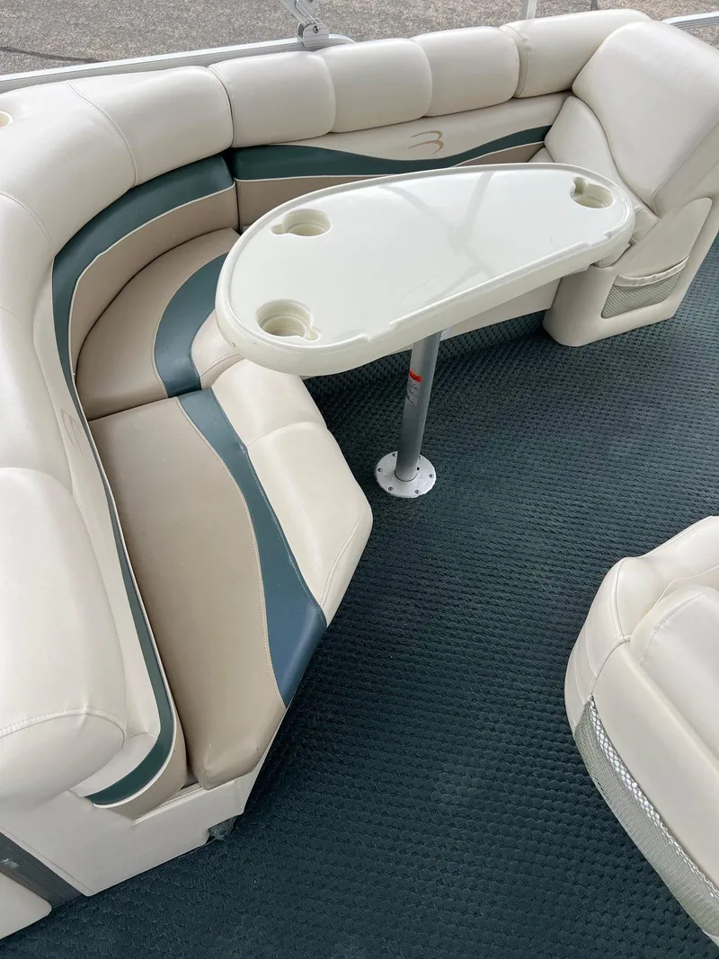 Slide: The Image of Luxurious seating area on a 2002 Bennington 2575 FS boat with a sleek table design. - 34