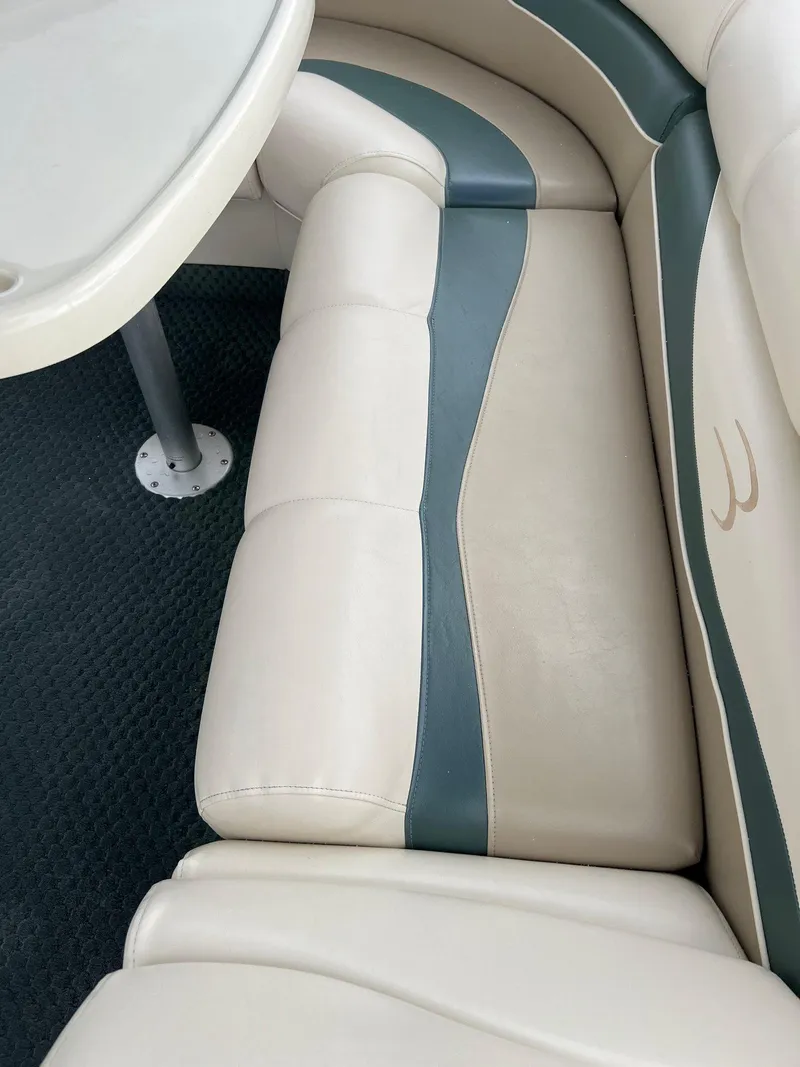 Slide: The Image of 2002 Bennington 2575 FS boat interior with beige and green seating. - 36
