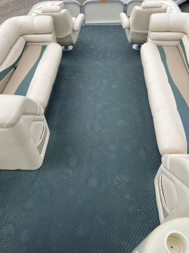 Slide: The Image of 2002 Bennington 2575 FS boat interior with beige seating and blue carpet. - 42
