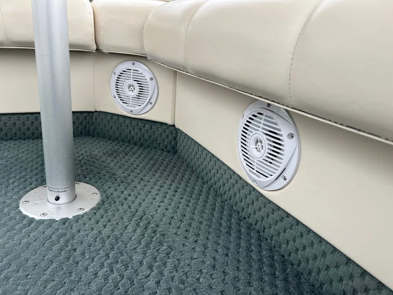 Slide: The Image of Bennington 2575 FS 2002 boat interior with beige seating and built-in speakers. - 45