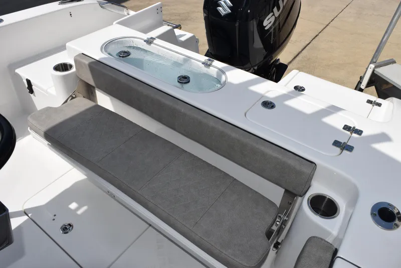 Slide: The Image of 2023 Sea Pro 219 Deep V CC boat with cushioned seating and Suzuki outboard motor. - 11