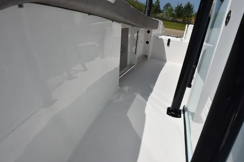 Slide: The Image of 2023 Sea Pro 219 Deep V CC boat interior, showcasing sleek white deck and side panel. - 15