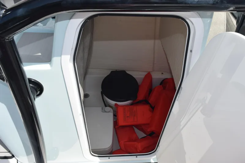 Slide: The Image of 2023 Sea Pro 219 Deep V CC boat storage with life jackets and portable toilet. - 19