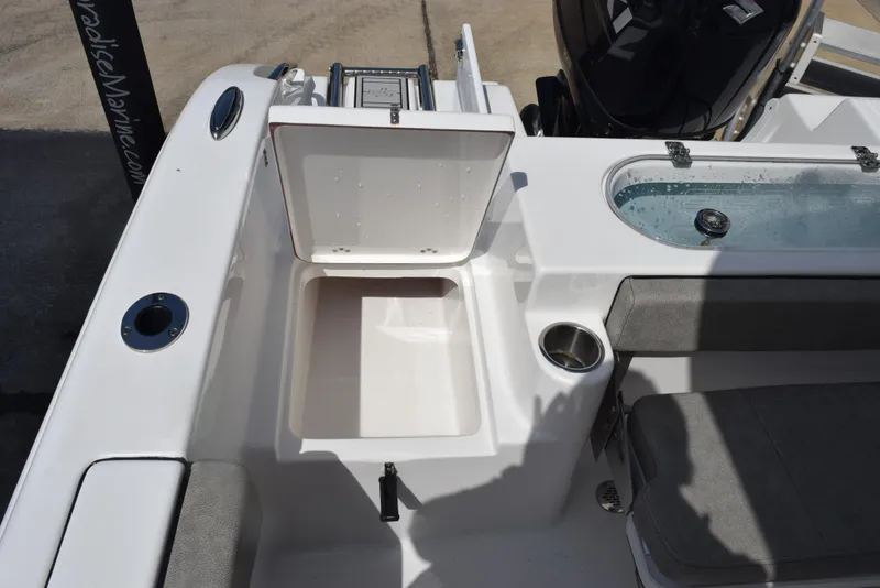 Slide: The Image of 2023 Sea Pro 219 Deep V CC boat interior with open storage compartment and seating. - 22