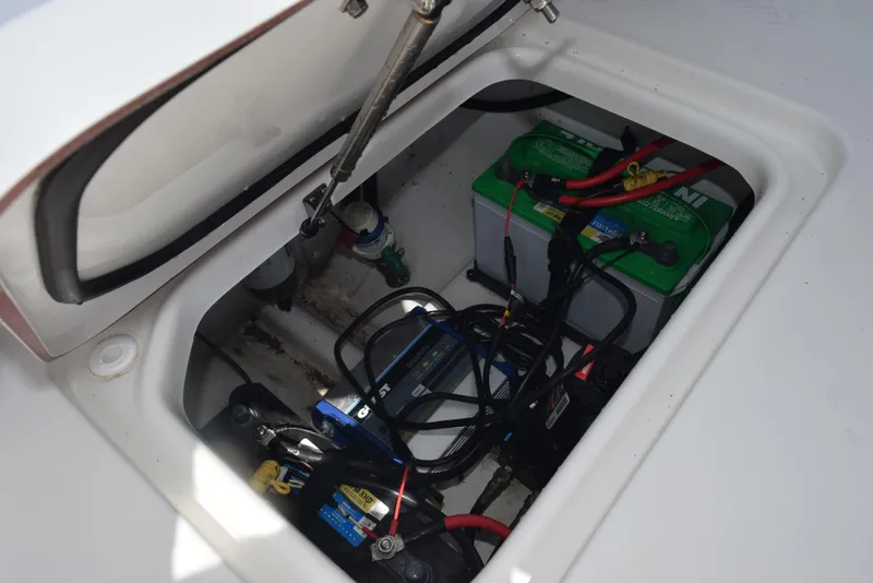 Slide: The Image of 2023 Sea Pro 219 Deep V CC battery compartment with wiring and components. - 24