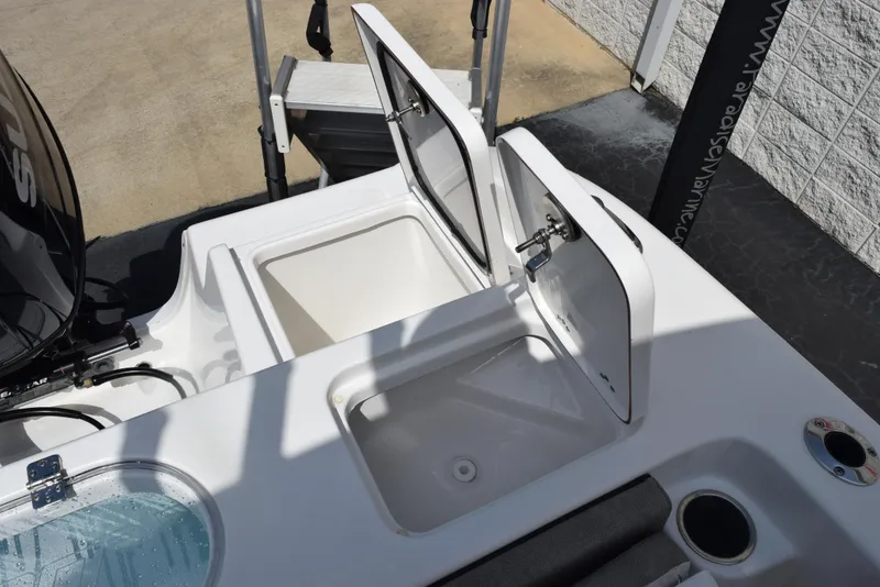 Slide: The Image of 2023 Sea Pro 219 Deep V CC boat storage compartments open on deck. - 25