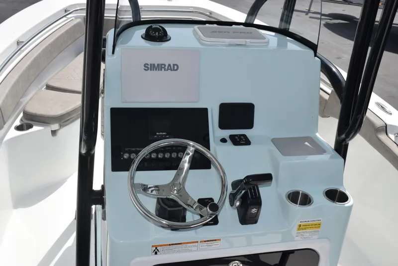 Slide: The Image of 2023 Sea Pro 219 Deep V CC boat console with steering wheel and Simrad display. - 8