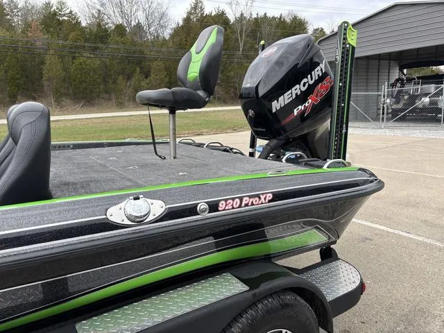 Slide: The Image of 2014 Phoenix Bass Boats 920 ProXP with Mercury Pro XS engine, parked outdoors. - 11