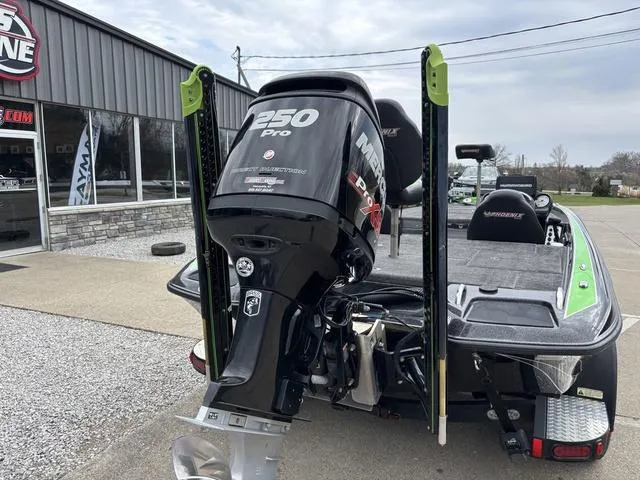 Slide: The Image of 2014 Phoenix Bass Boats 920 ProXP with Mercury 250 Pro engine, parked outside a showroom. - 2