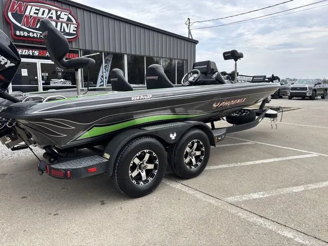 Slide: The Image of 2014 Phoenix Bass Boats 920 ProXP in parking lot, featuring sleek design and green accents. - 4