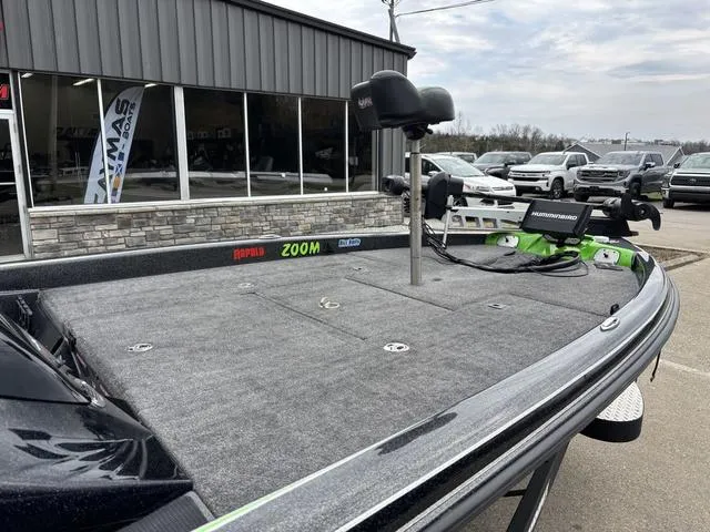 Slide: The Image of 2014 Phoenix Bass Boats 920 ProXP with trolling motor, parked outside a dealership. - 6
