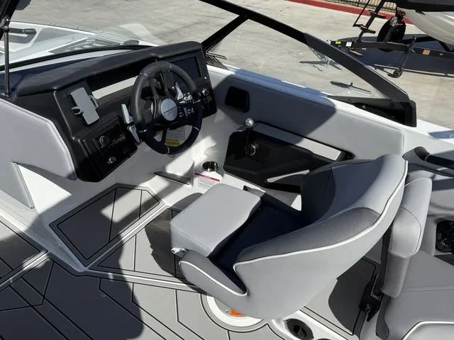 Slide: The Image of 2025 Moomba Max boat interior with modern steering and seating design. - 11