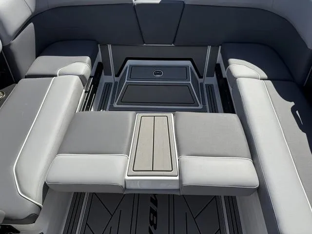 Slide: The Image of 2025 Moomba Max boat interior with gray seating and sleek design. - 12