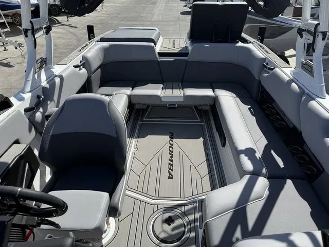Slide: The Image of 2025 Moomba Max boat interior with gray seating and sleek design. - 8
