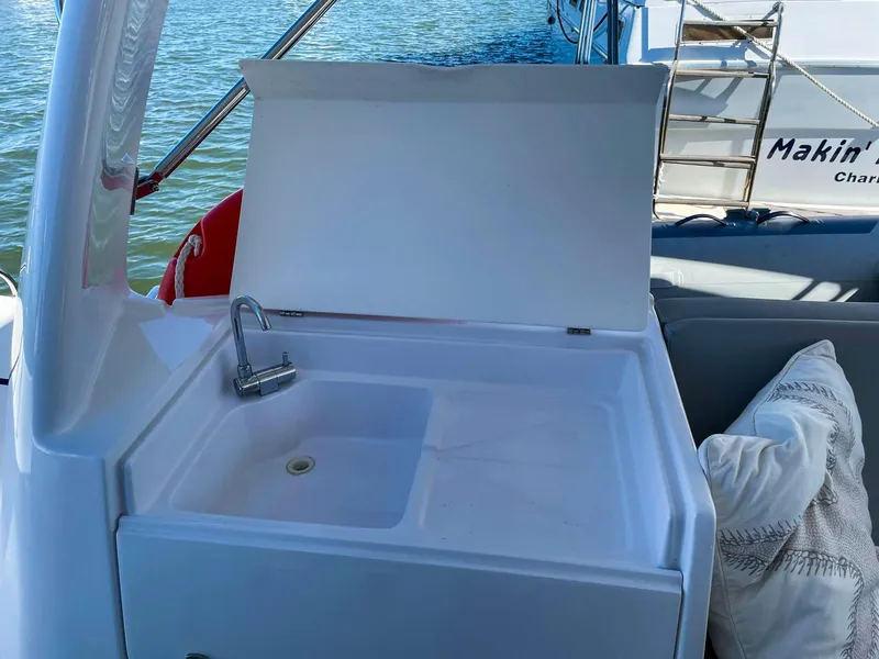 Slide: The Image of Seawind 1260 yacht sink area with faucet, 2023 model, on calm water. - 12