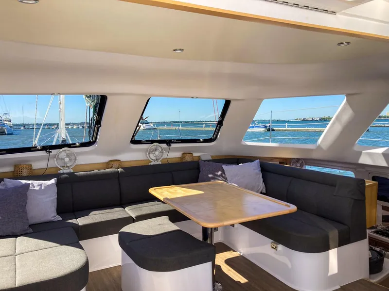 Slide: The Image of Interior of 2023 Seawind 1260 catamaran with spacious seating and ocean view. - 20