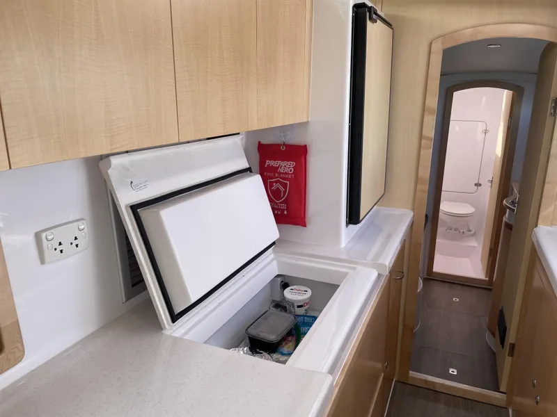 Slide: The Image of 2023 Seawind 1260 yacht interior with kitchen and bathroom view. - 26