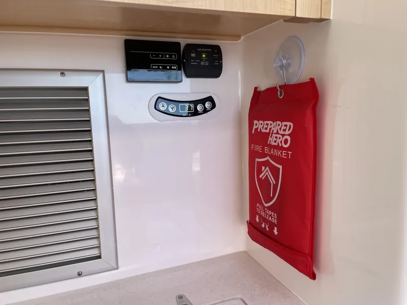 Slide: The Image of 2023 Seawind 1260 interior with fire blanket and control panels. - 28