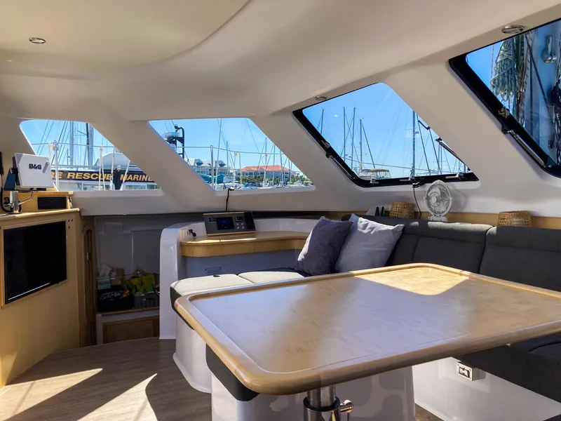 Slide: The Image of Interior of 2023 Seawind 1260 catamaran with spacious seating and large windows. - 29