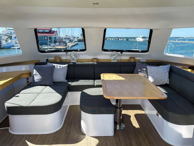 Slide: The Image of 2023 Seawind 1260 catamaran interior with spacious seating and ocean view. - 31