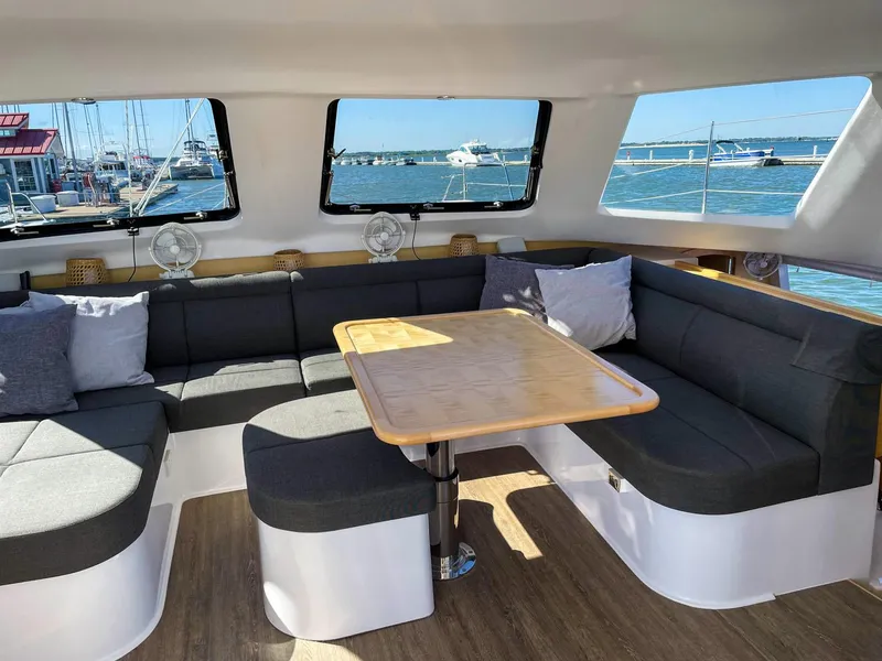 Slide: The Image of Interior of 2023 Seawind 1260 catamaran with spacious seating and ocean view. - 32
