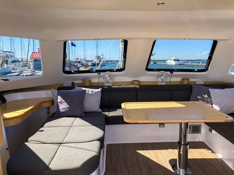 Slide: The Image of Interior of 2023 Seawind 1260 catamaran with spacious seating and large windows. - 42